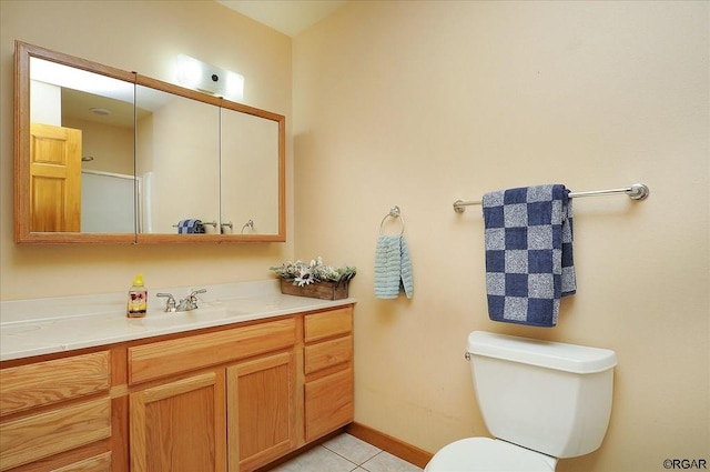 bathroom with tile patterned flooring, vanity, and toilet