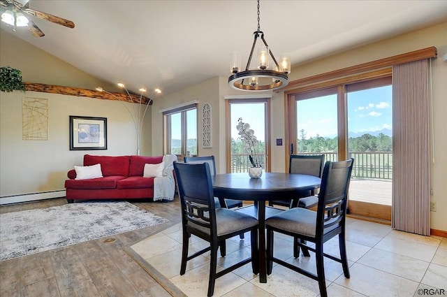 dining room with vaulted ceiling, a chandelier, and a baseboard radiator