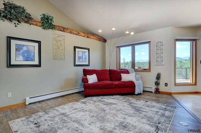 living room with hardwood / wood-style flooring, a healthy amount of sunlight, and a baseboard heating unit