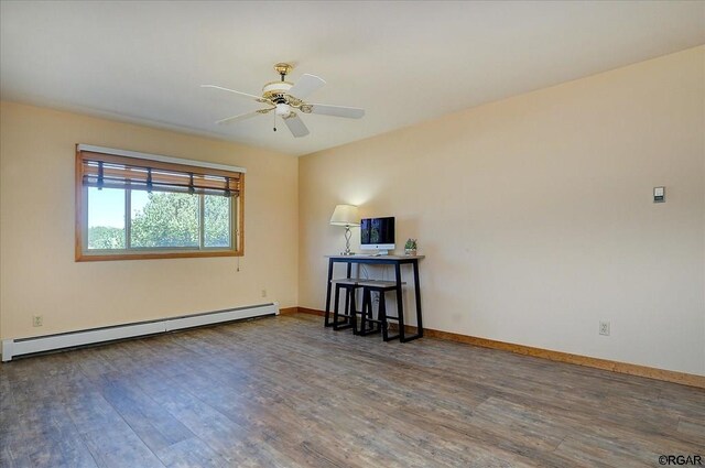 spare room with baseboard heating, ceiling fan, and dark hardwood / wood-style flooring