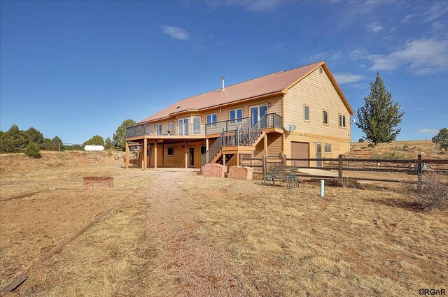 back of house featuring a deck