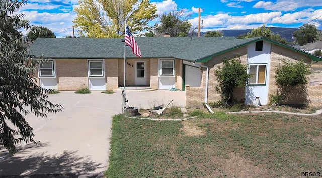 single story home featuring a garage and a front lawn