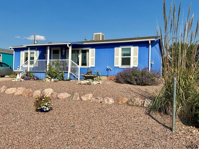 view of front of home with cooling unit and covered porch