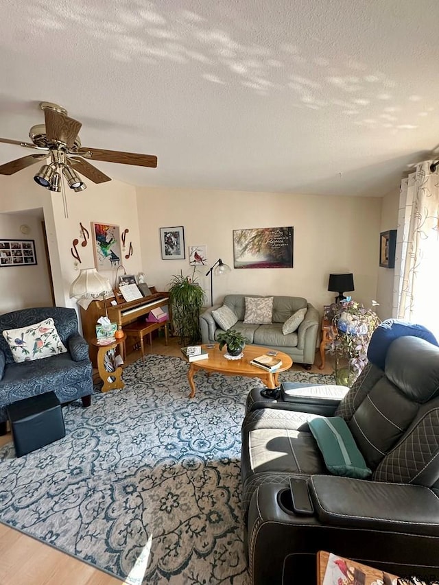 living room with ceiling fan, hardwood / wood-style floors, and a textured ceiling