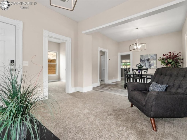 932 Elm St, Pueblo, CO 81004 - living room featuring a chandelier, light colored carpet, and baseboards