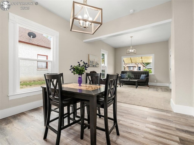 932 Elm St, Pueblo, CO 81004 - dining area featuring a chandelier, baseboards, and light wood-style flooring