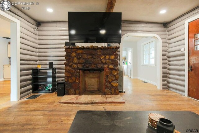 living room featuring hardwood / wood-style flooring and a fireplace