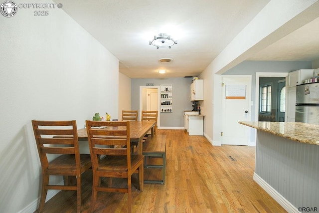 dining area featuring light wood-type flooring