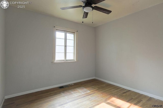 spare room with ceiling fan and wood-type flooring