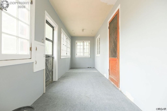 hallway with light colored carpet