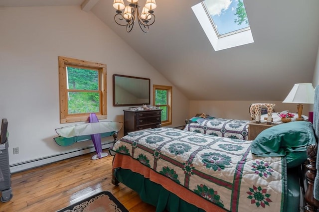 bedroom featuring lofted ceiling with skylight, a baseboard heating unit, a chandelier, and light hardwood / wood-style floors