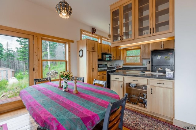 dining space with light hardwood / wood-style flooring and a high ceiling