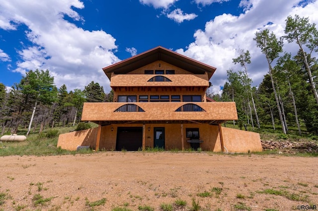 back of house featuring a garage