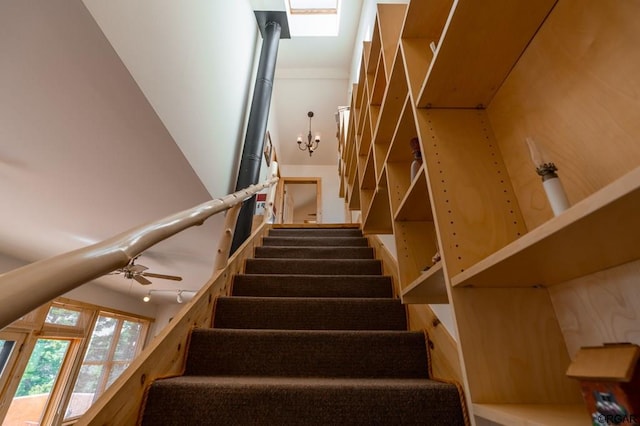 stairs featuring ceiling fan