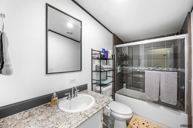 full bathroom featuring vanity, toilet, and combined bath / shower with glass door