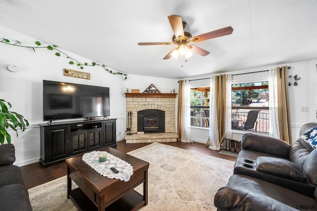 living room featuring dark wood-type flooring and ceiling fan