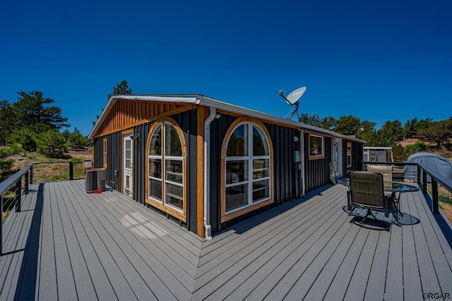 wooden deck featuring central AC unit