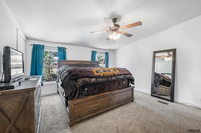 bedroom with light carpet, vaulted ceiling, and ceiling fan