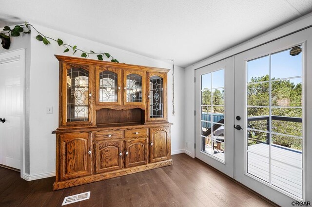 doorway with dark hardwood / wood-style flooring and french doors