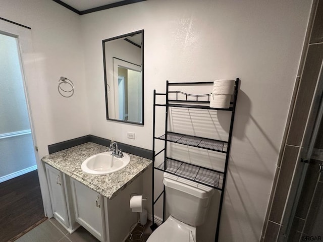 bathroom featuring vanity, tile patterned floors, and toilet