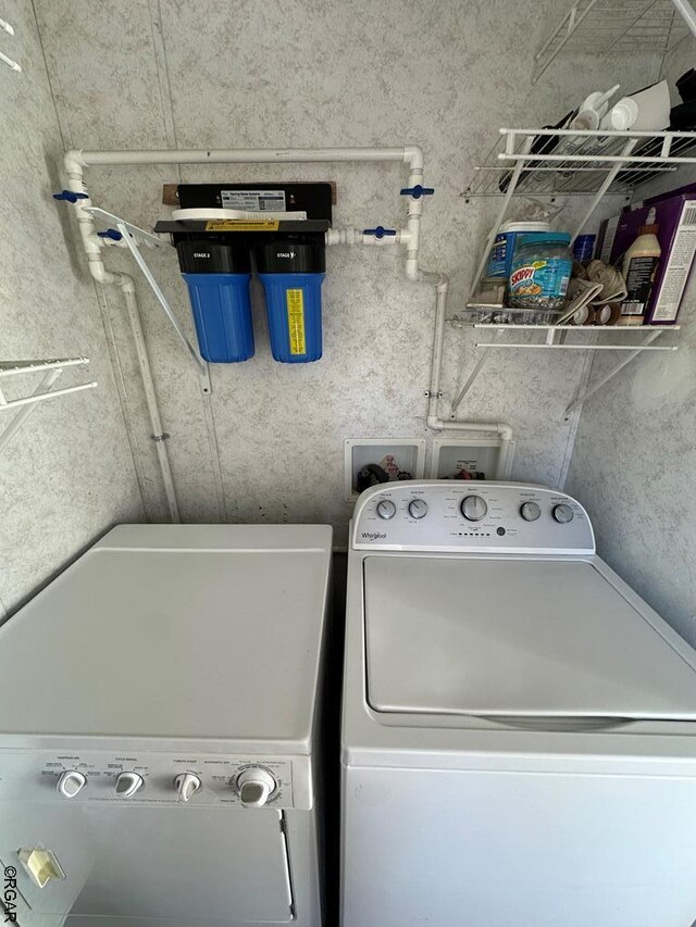 washroom with independent washer and dryer