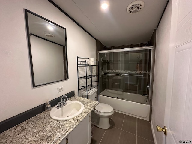 full bathroom with vanity, combined bath / shower with glass door, tile patterned floors, and toilet