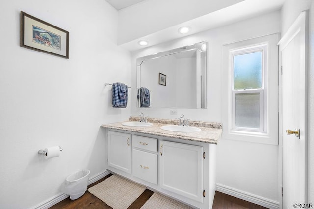 bathroom with vanity and wood-type flooring