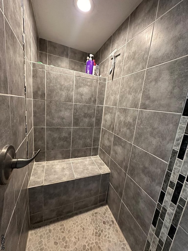 bathroom with a tile shower