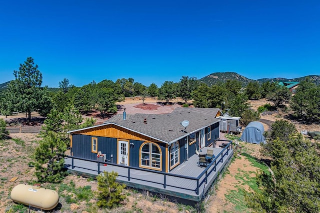 back of house with a deck with mountain view