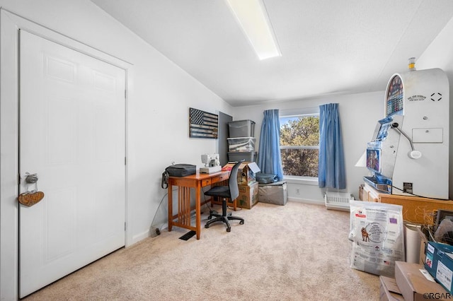 carpeted office space featuring lofted ceiling