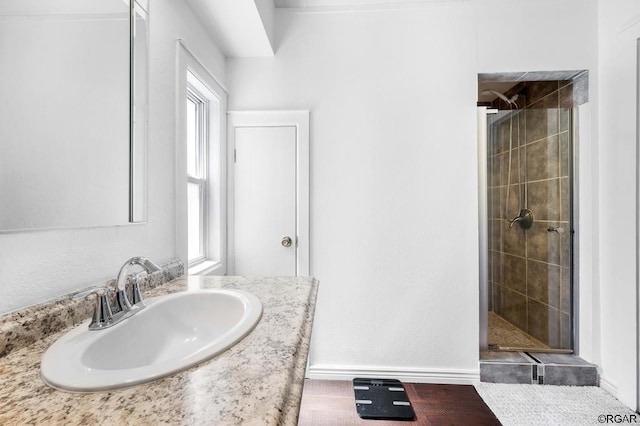 bathroom with vanity and a shower with door