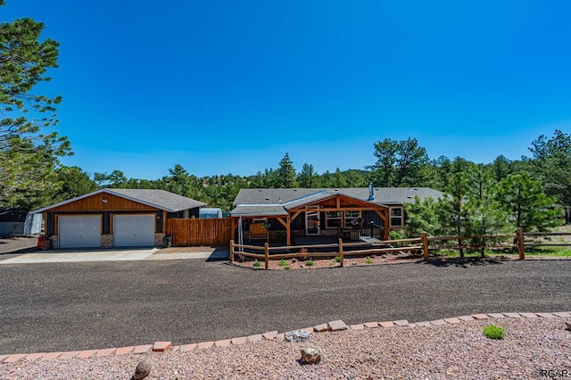 view of front of house featuring a garage and an outbuilding