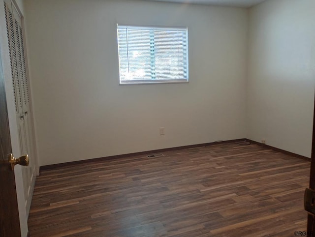 unfurnished room featuring dark hardwood / wood-style floors