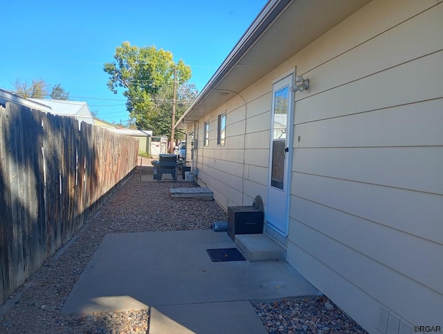 view of side of property featuring a patio area