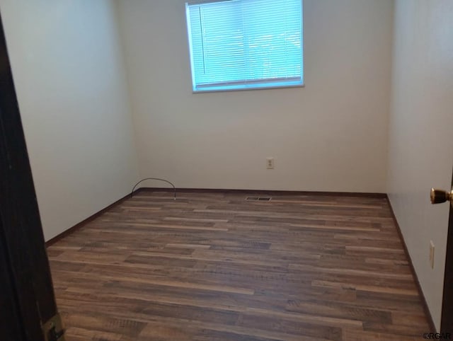 empty room featuring dark hardwood / wood-style flooring