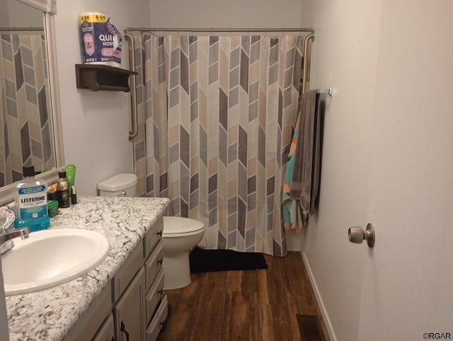 bathroom with vanity, hardwood / wood-style floors, toilet, and walk in shower