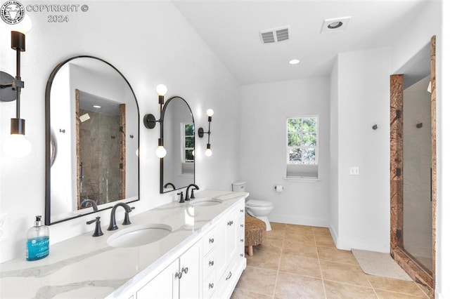 bathroom featuring tile patterned flooring, walk in shower, vanity, and toilet