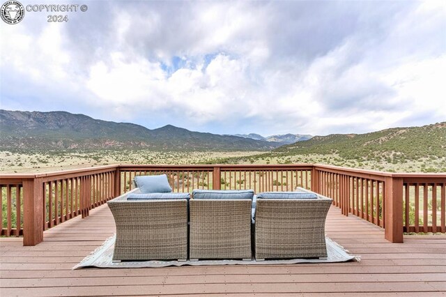 wooden deck featuring a mountain view