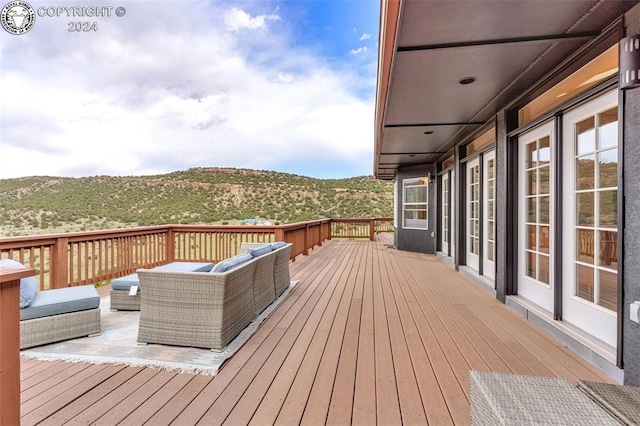 wooden terrace featuring outdoor lounge area and a mountain view