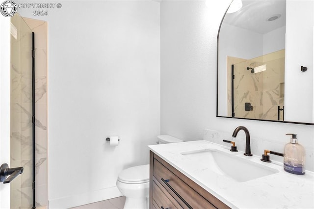 bathroom featuring vanity, an enclosed shower, and toilet