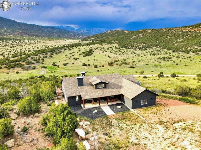 birds eye view of property with a mountain view