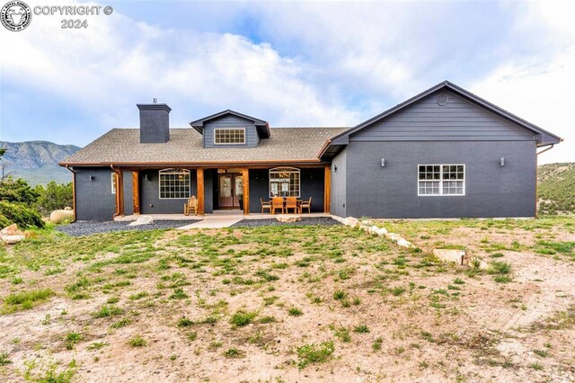 back of property featuring a mountain view