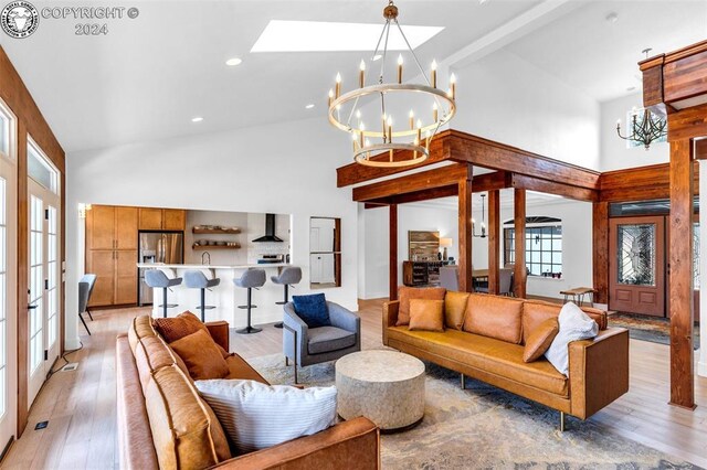 living room with french doors, high vaulted ceiling, light wood-type flooring, a notable chandelier, and beamed ceiling