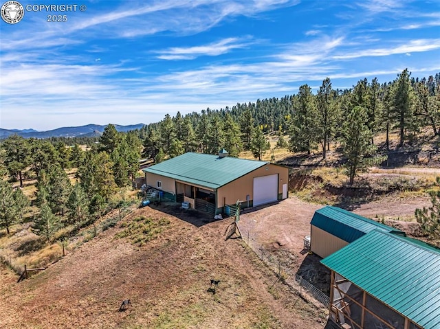 aerial view featuring a mountain view and a view of trees