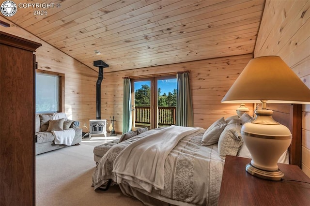 carpeted bedroom with wooden walls, wooden ceiling, a wood stove, access to exterior, and vaulted ceiling