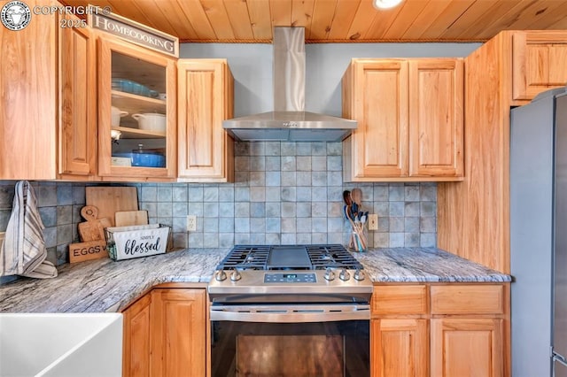 kitchen with tasteful backsplash, wooden ceiling, glass insert cabinets, appliances with stainless steel finishes, and wall chimney range hood