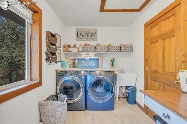 washroom featuring laundry area, attic access, and washer and clothes dryer