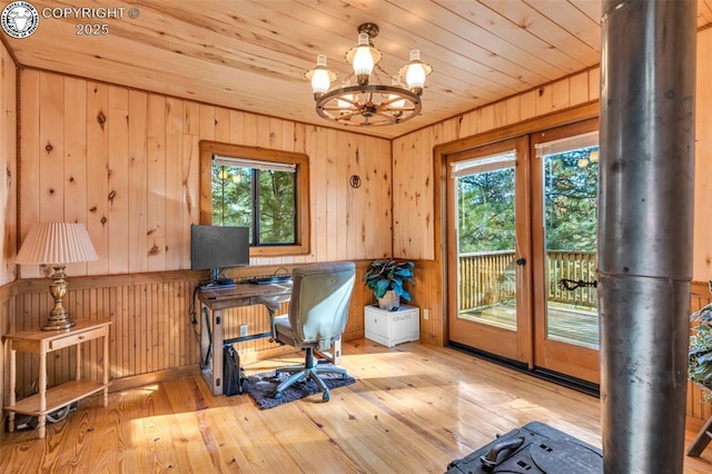 office area featuring wooden ceiling, wood walls, french doors, hardwood / wood-style floors, and an inviting chandelier