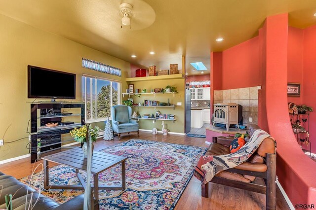 living room featuring hardwood / wood-style floors and a skylight