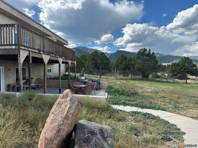 exterior space with a deck with mountain view and a patio area